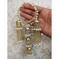 Gold-tone statement bangles featuring long hanging jhumkas, chains, and white pearls.