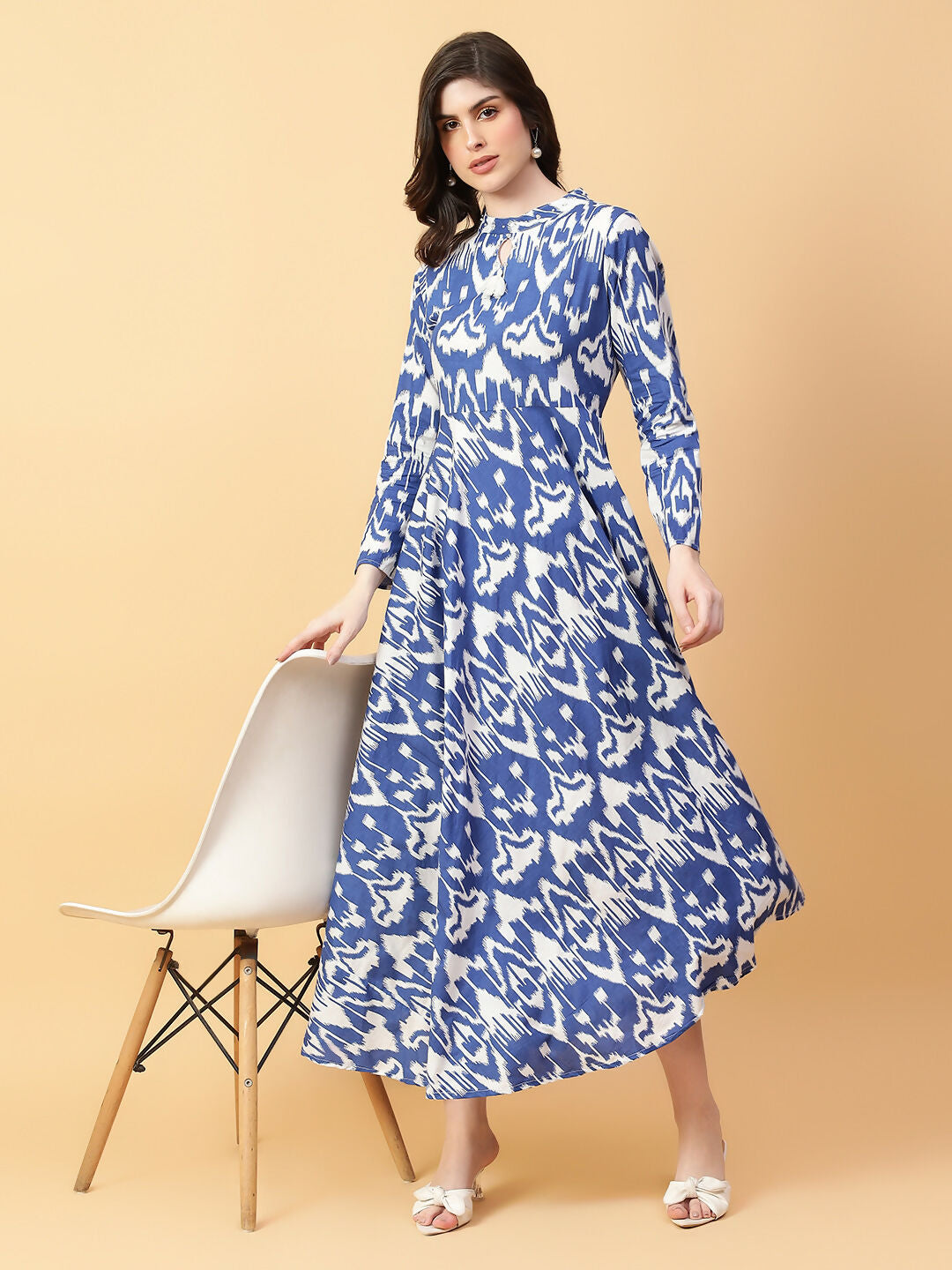 A beautiful blue cotton printed dress featuring intricate hand-work details and a flowy silhouette.
