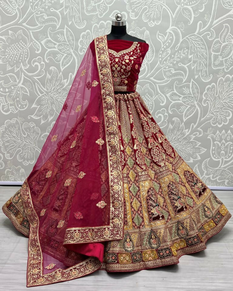 Rani Pink velvet wedding lehenga choli with heavy Dori, Zari, and multi-thread embroidery.