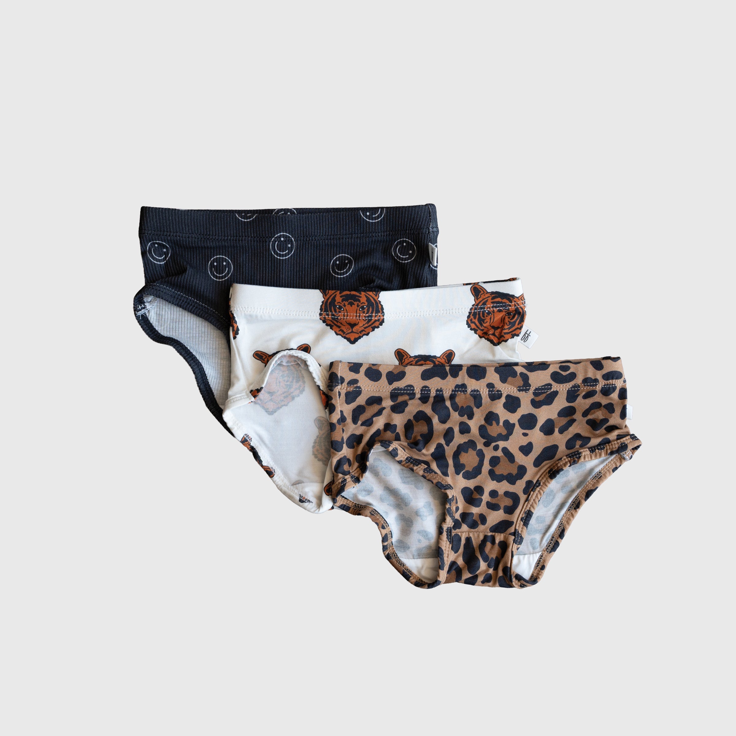 Three-pack of girls' underwear featuring leopard, tiger, and smiley face prints in a soft knit fabric