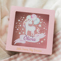 Personalized pink and natural-wood acrylic storage box with a unicorn motif for a child's nursery