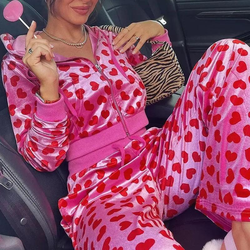 Pink velvet zip-up cropped bomber jacket with heart graphic print and drawstring hood
