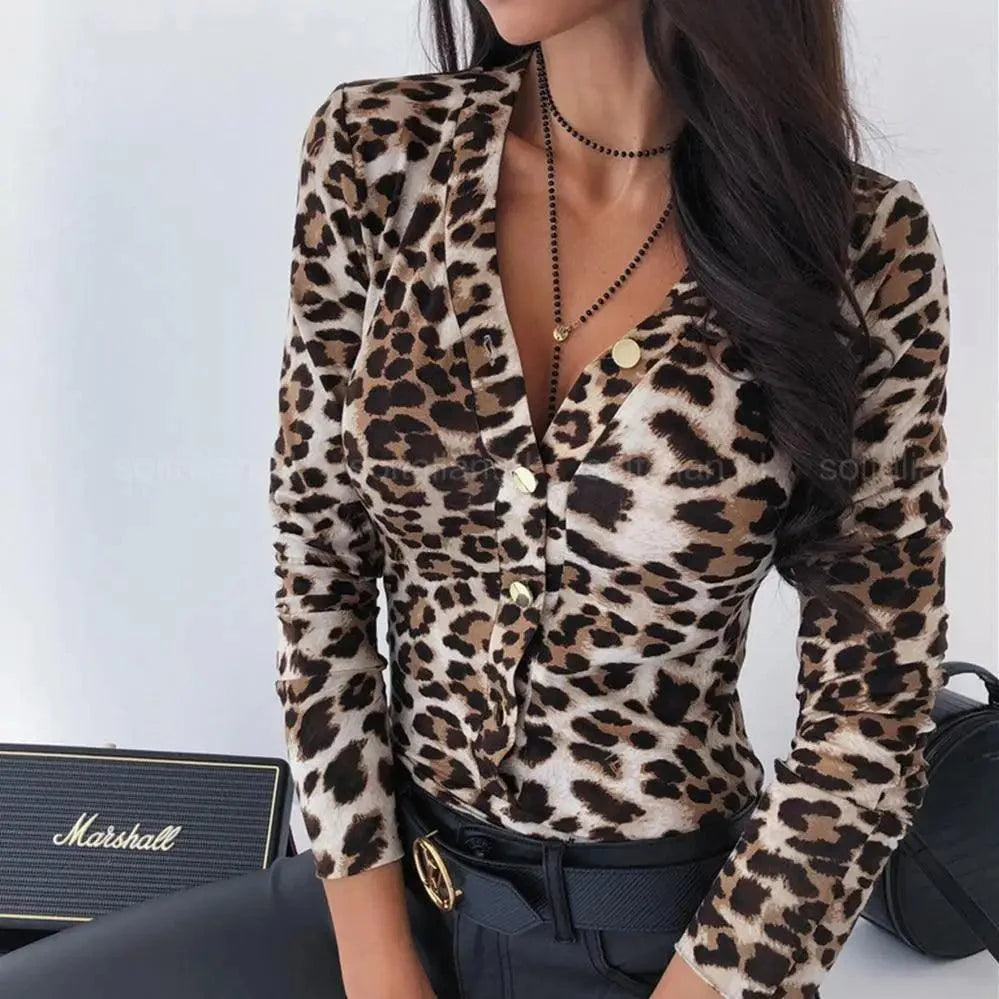 Close-up of a women's snakeskin and leopard print button-down blouse with a V-neckline and slim fit.