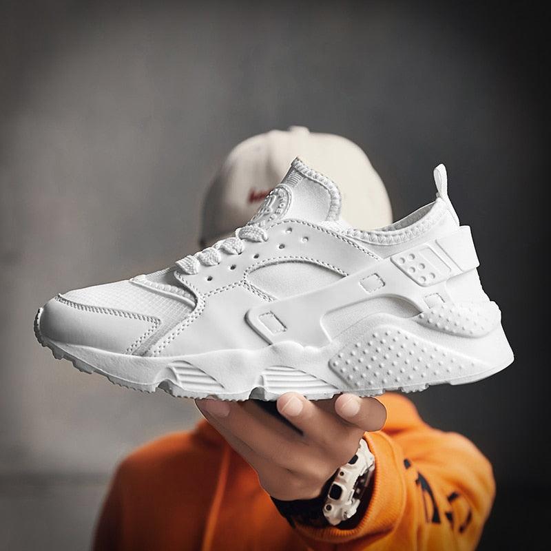 Stevvex unisex white mesh sports trainers with a clean, modern design and breathable fabric.