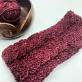 Twin cable crochet headband in deep burgundy knit material styled for winter