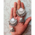 Bollywood style silver half-moon jhumki earrings with mirror work accents.