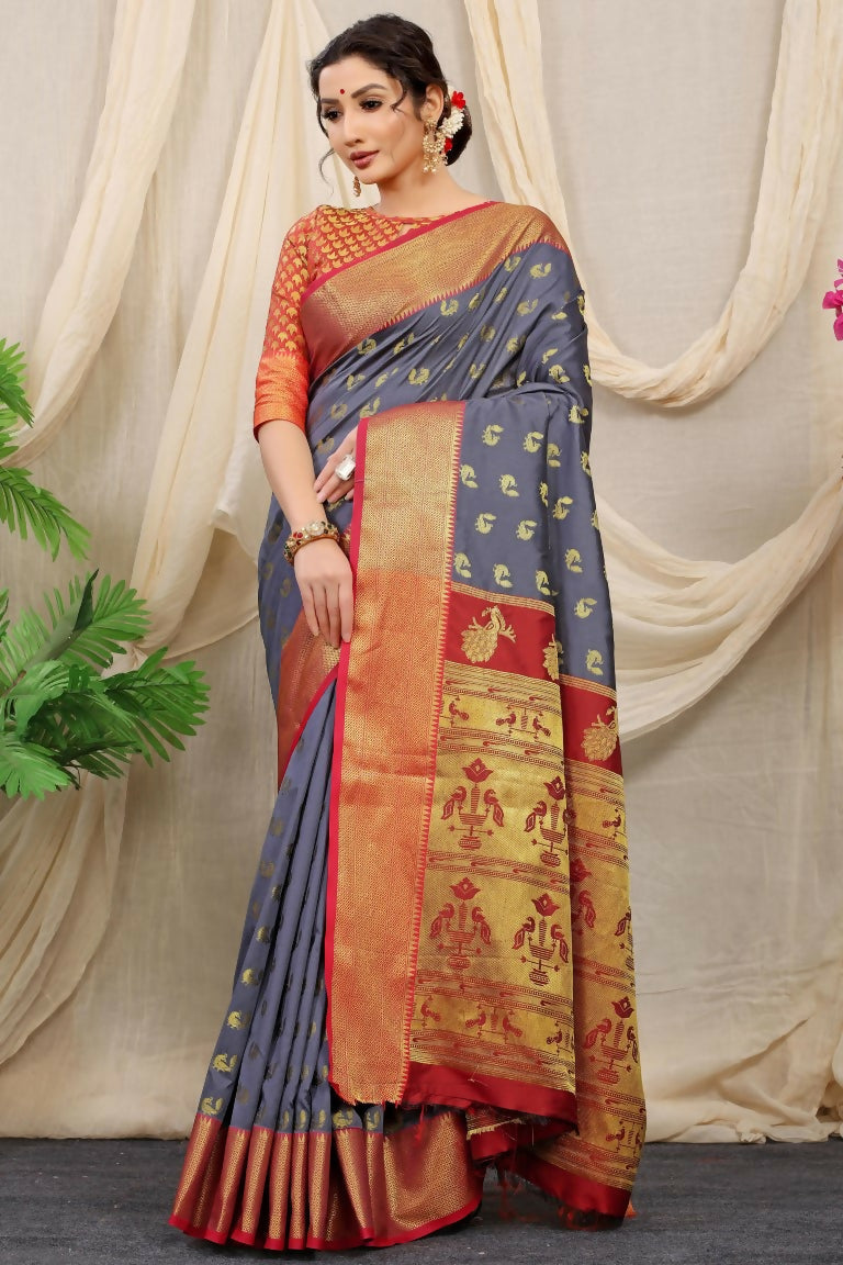Elegant grey Banarasi silk saree with intricate gold zari woven border and a vibrant red blouse piece.