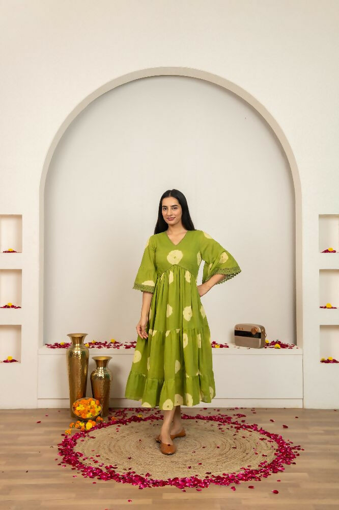 Woman wearing a green tie and dye cotton dress with a casual, relaxed fit