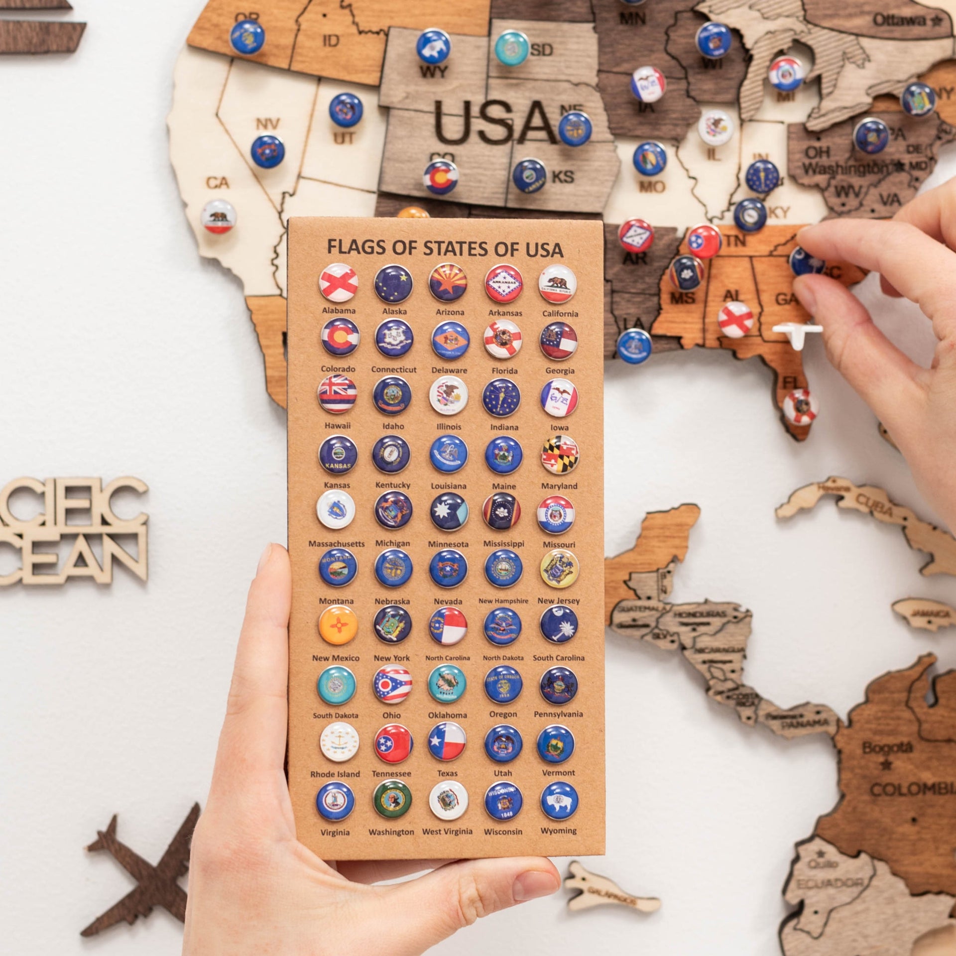 Multi-colored USA state flag push pins used to mark locations on a map