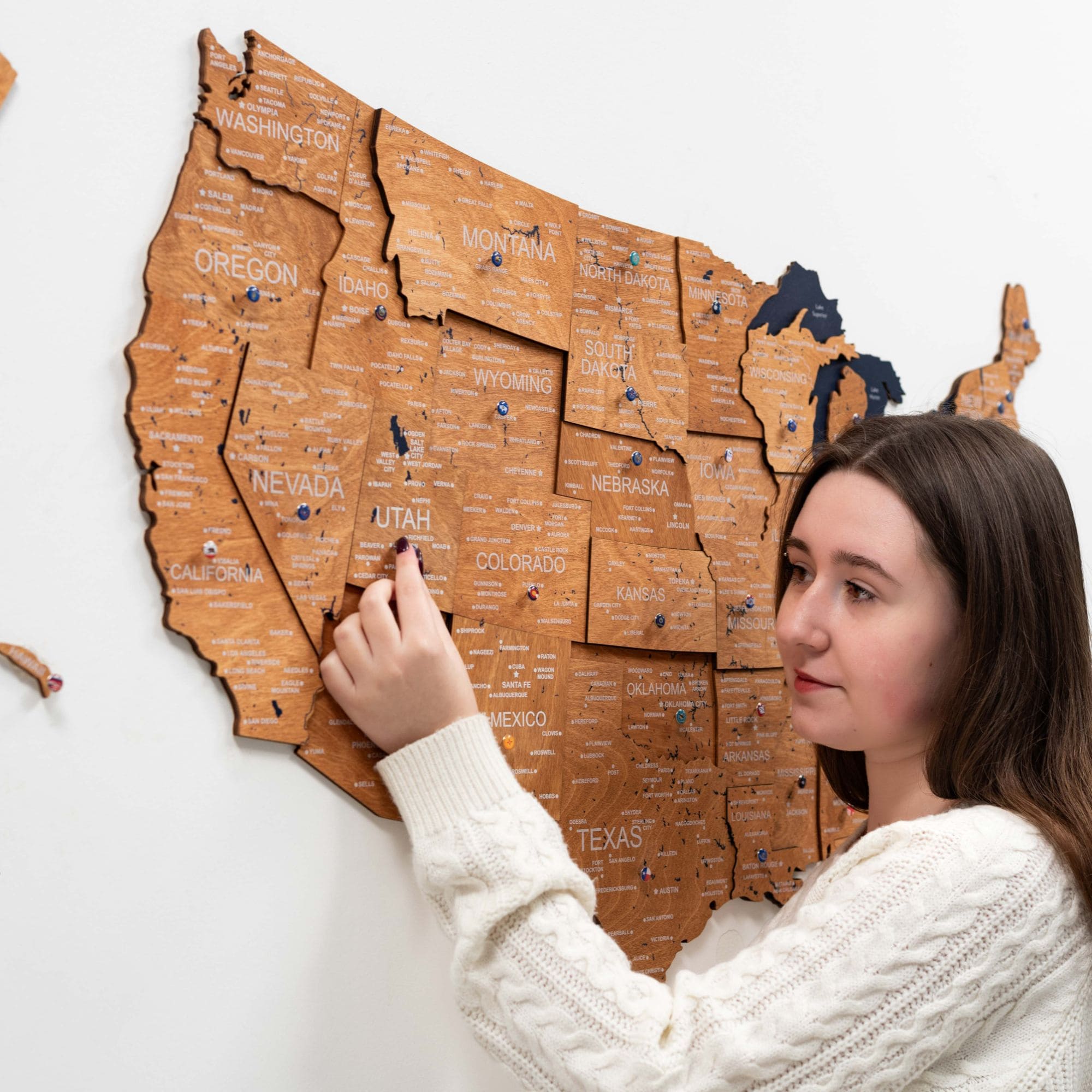 3D wooden USA map with natural oak finish mounted on a modern living room wall