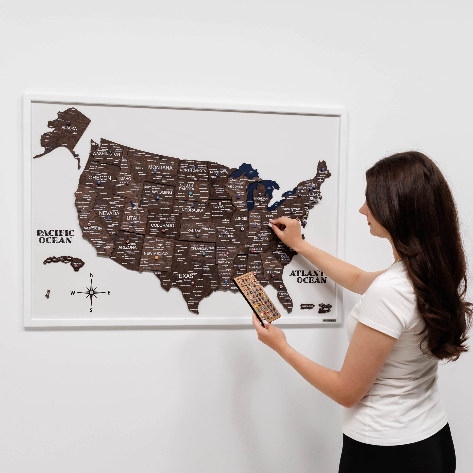 3D wooden USA map with a dark walnut finish mounted on a wall