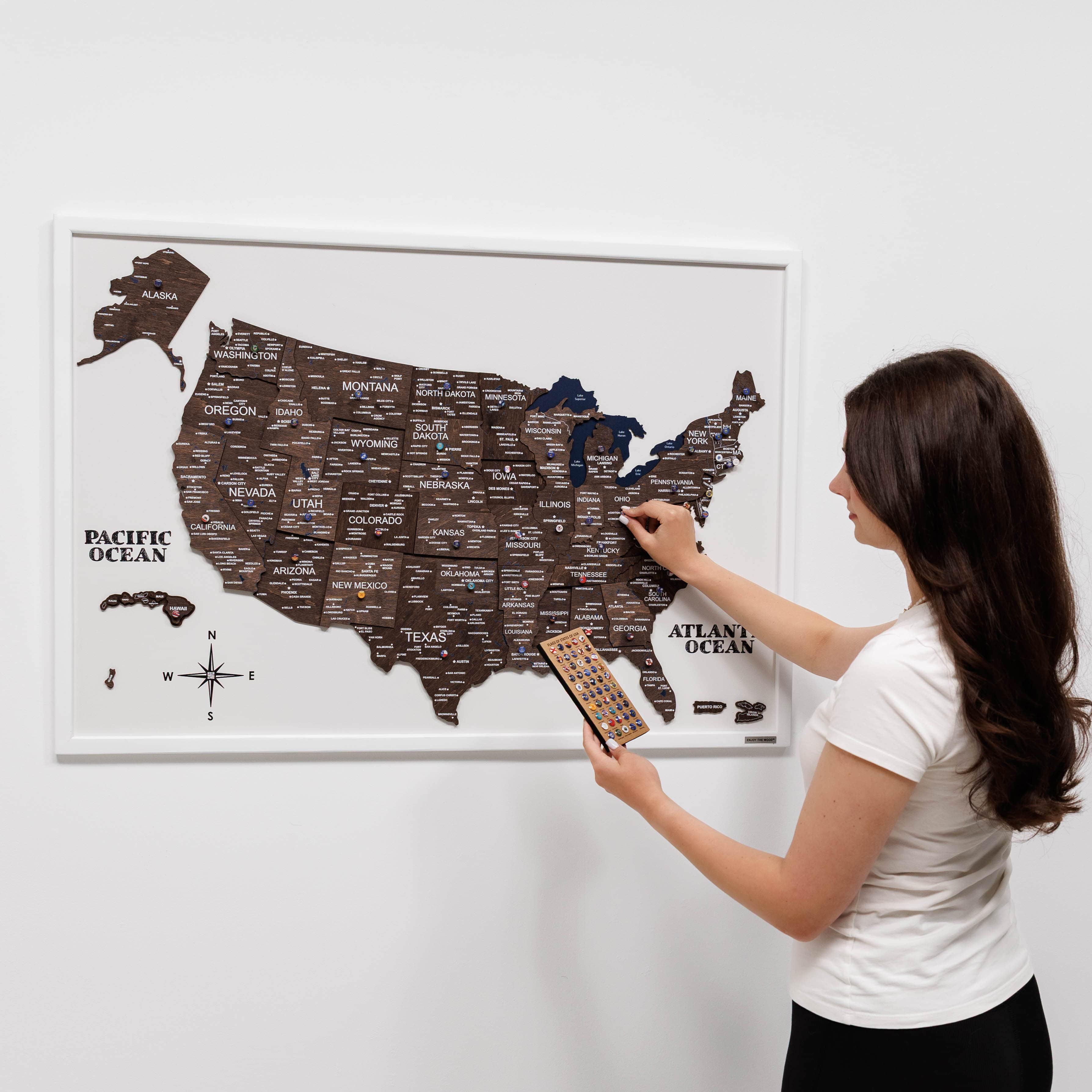 3D wooden USA map with a dark walnut finish mounted on a wall