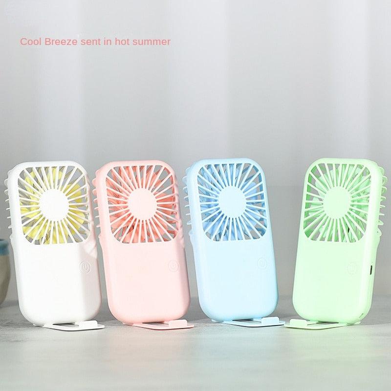 Minimalist portable handheld USB fan available in pink, blue, green, and white.