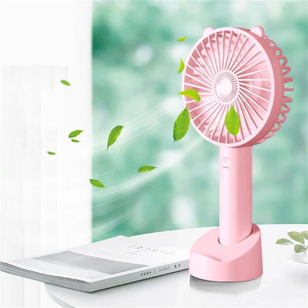 Small handheld USB rechargeable fan with white charging base