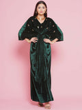 Elegant green velvet gown featuring intricate hand-embellished detailing for evening wear.