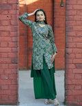 Close up of a green silk kurti with detailed embroidery paired with a matching sharara