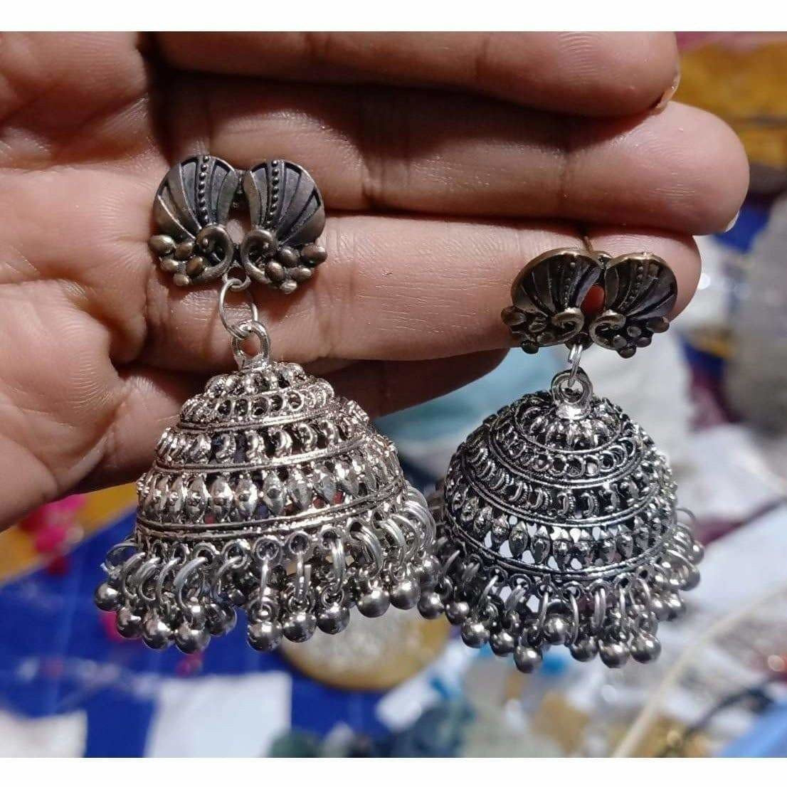 Silver tone bee-shaped jhumka earrings with a rustic oxidized finish.