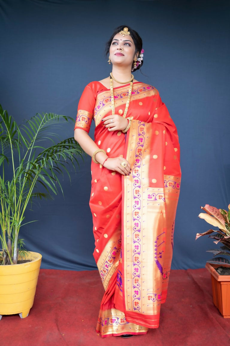 Traditional red Paithani silk saree with elegant Zari woven patterns and matching blouse.