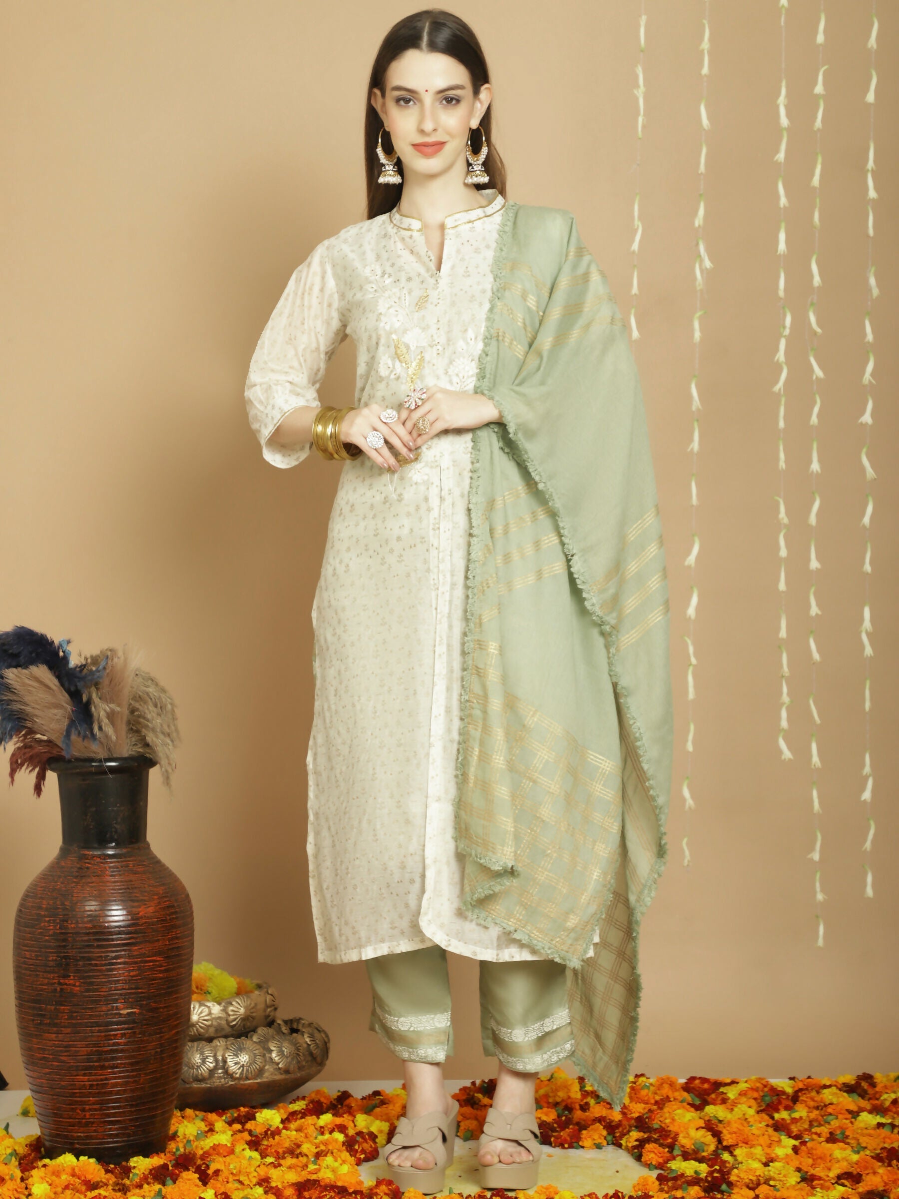 Woman wearing an elegant off white Chanderi silk A-line kurta set with Jardoshi work and a cotton dupatta