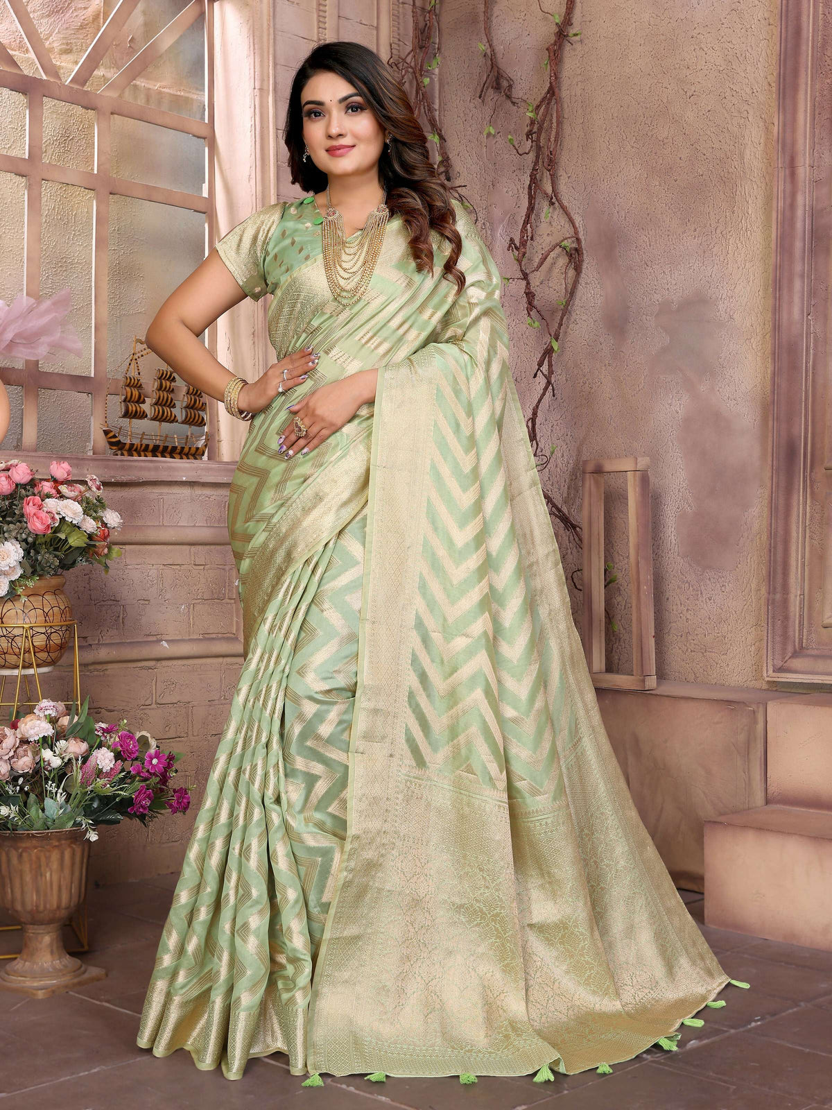A Pista green Soft Organza Silk saree with fine weaving details, styled for a modern ethnic appearance.