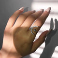 Close-up of a stylish silver brass adjustable ring with a polished finish