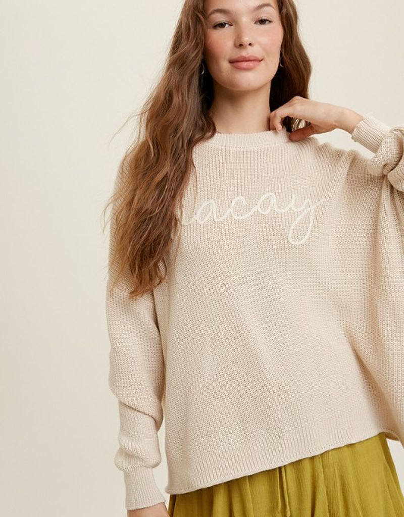 Natural cream knit sweater with Vacay handstitched lettering in a relaxed crewneck fit
