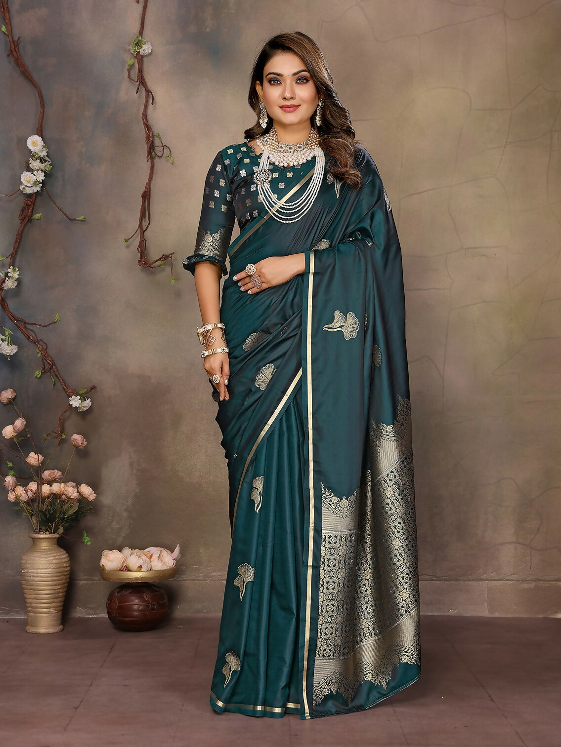 Teal satin silk Banarasi saree with beautiful floral patterns and an unstitched blouse