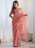 Peach organza party wear saree featuring delicate thread work and lace border.