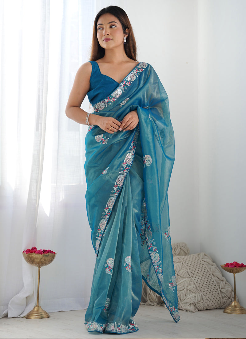 Rama color organza saree with intricate thread work and heavy lace border detailing.