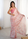 Baby girl wearing a baby pink Chinon silk designer saree with a glittery mirror-work border for a festive look.