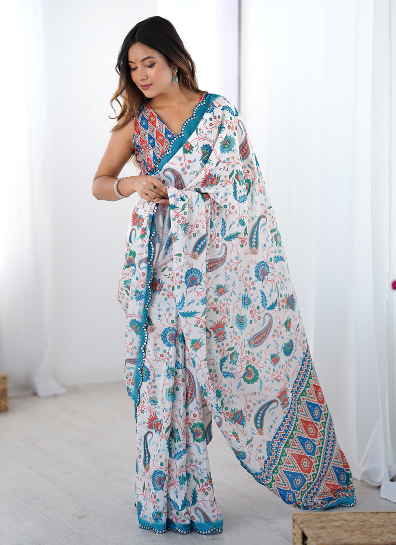 Off-white and sky blue printed Chinon silk saree with mirror work trim.