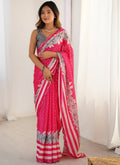 Pink Chinon Silk saree featuring vibrant prints and an intricate mirror work lace border