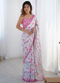 Young girl wearing an elegant off-white Chinon silk designer saree with heavy mirror work borders.