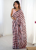 Peach-colored Chinon silk saree with printed patterns and a mirror work border.