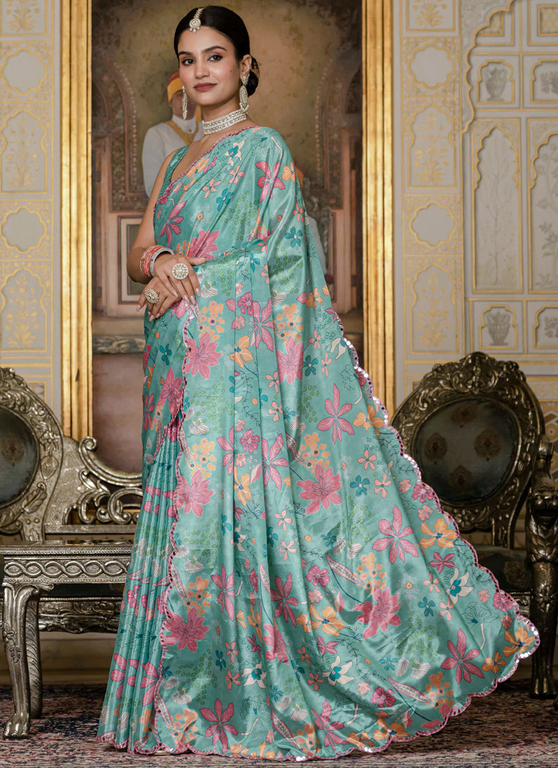 Sky blue floral print Chinon silk saree with decorative mirror cut border.