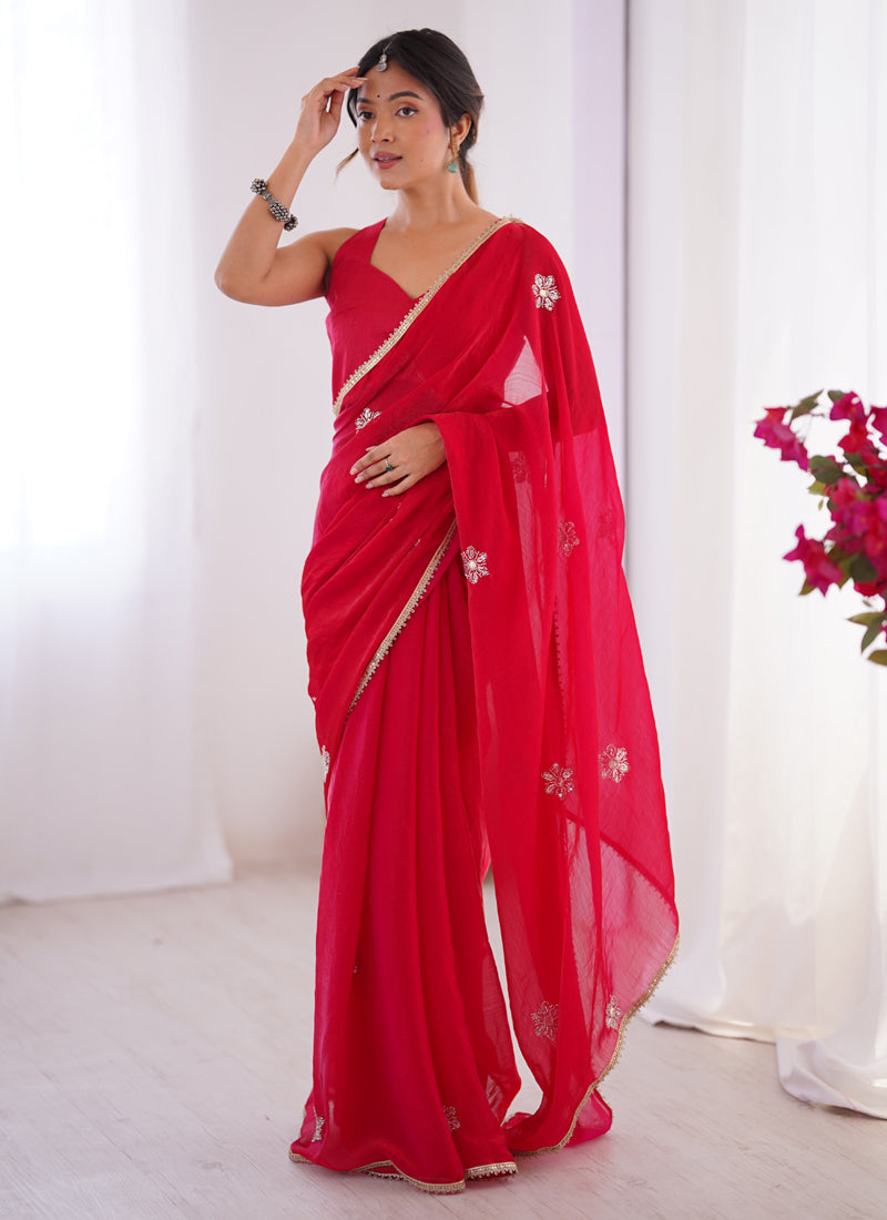 Model wearing a vibrant red Fandy silk saree with intricate Moti and Val sequence embroidery and a heavy lace border.