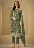 Woman wearing an olive-green chinon salwar suit with gold sequence and resham embroidery for festive events.
