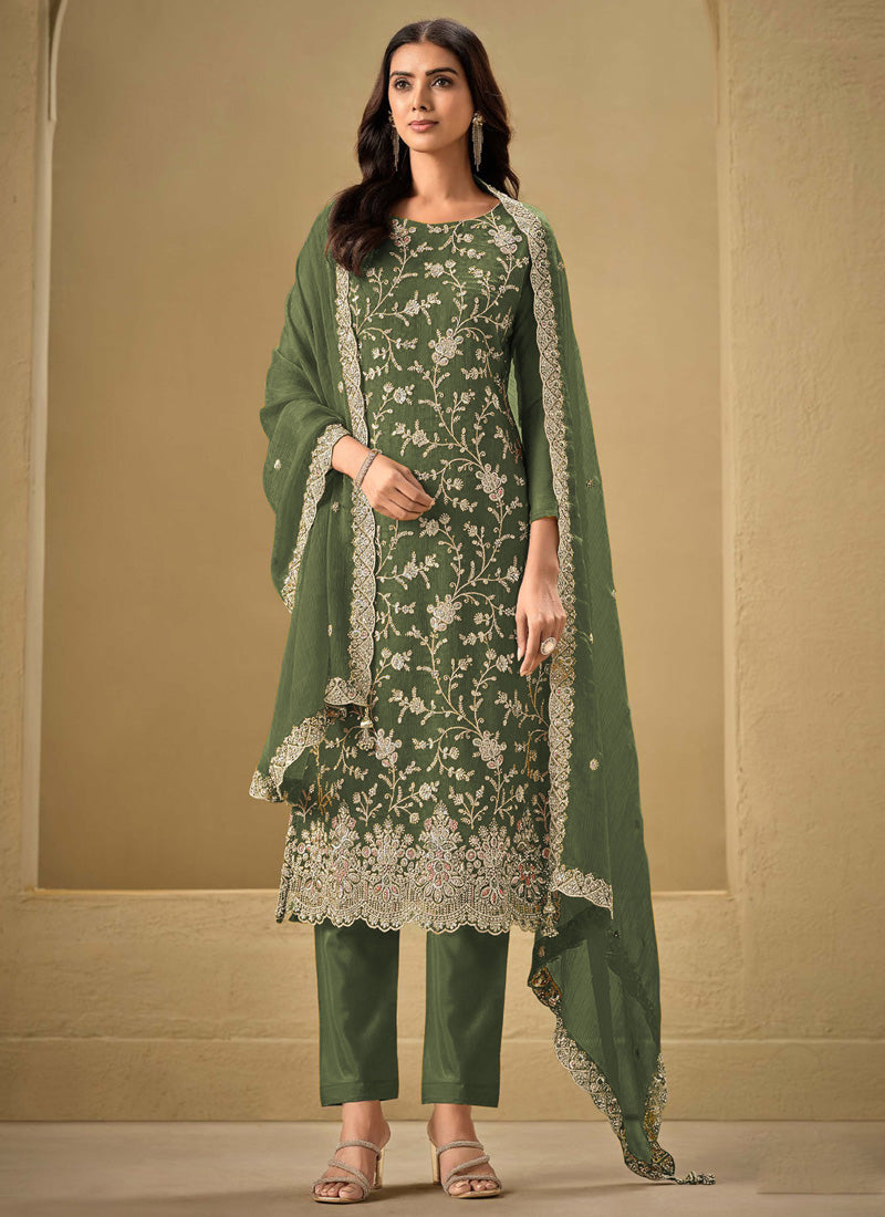 Woman wearing an olive-green chinon salwar suit with gold sequence and resham embroidery for festive events.