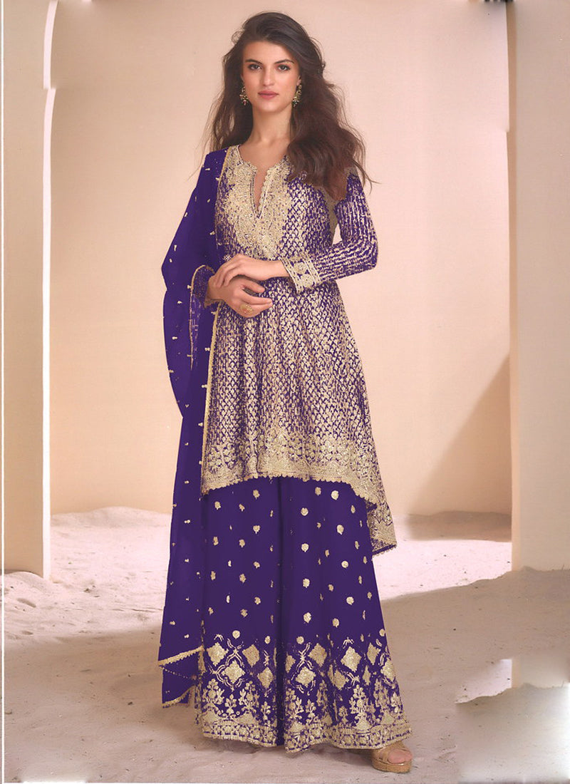 Woman wearing a violet georgette palazzo suit with intricate gold gota patti embroidery for festive occasions.