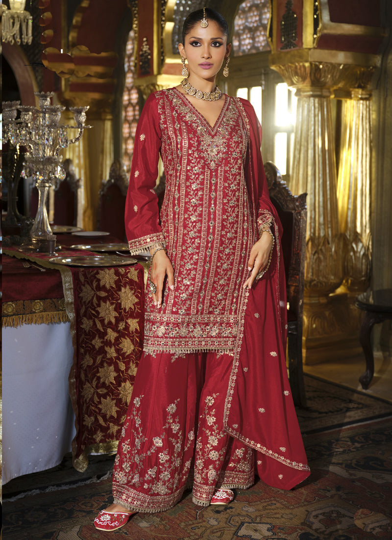 Woman wearing a maroon chinon silk palazzo suit with detailed gota patti embroidery