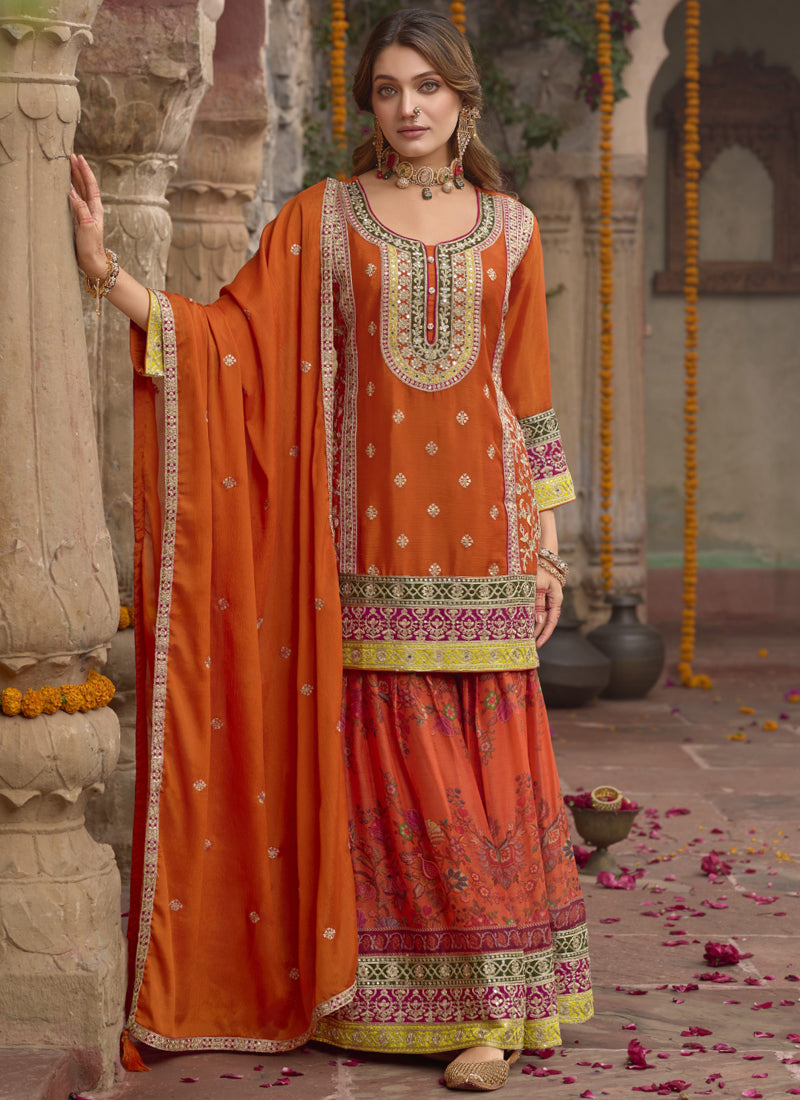 Vibrant orange Chinon silk A-line sharara suit with embroidery and matching dupatta.