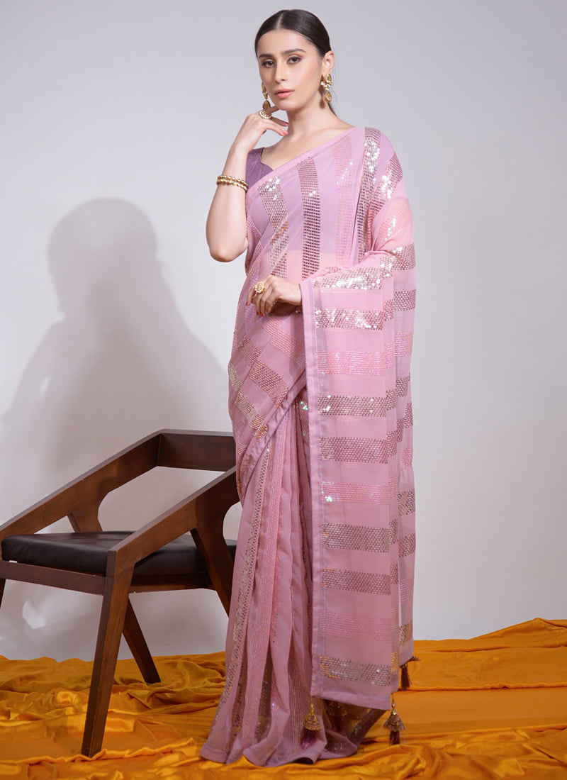 Baby girl wearing a baby pink georgette party wear saree with sequin embroidery