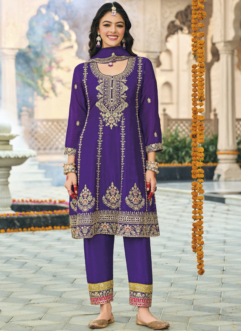 Woman wearing a violet Chinon silk designer palazzo suit with gold embroidery and mirror work