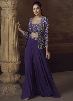 A woman wearing a violet real Chinon silk jacket style palazzo suit with gold embroidery and sequins.