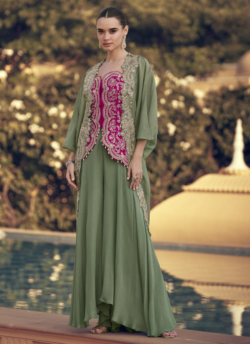 Woman wearing a mehendi green and magenta pink embroidered chinon silk palazzo suit with gota patti detailing.