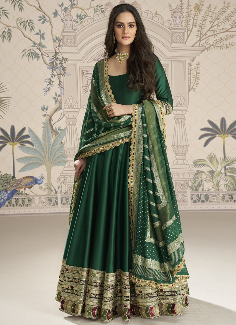 A green viscose jacquard silk embroidered gown with a matching dupatta for wedding and festive wear.