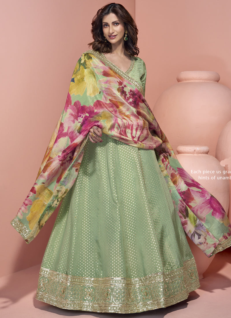 Pista green viscose jacquard silk Anarkali suit with intricate embroidery and gota patti detail.