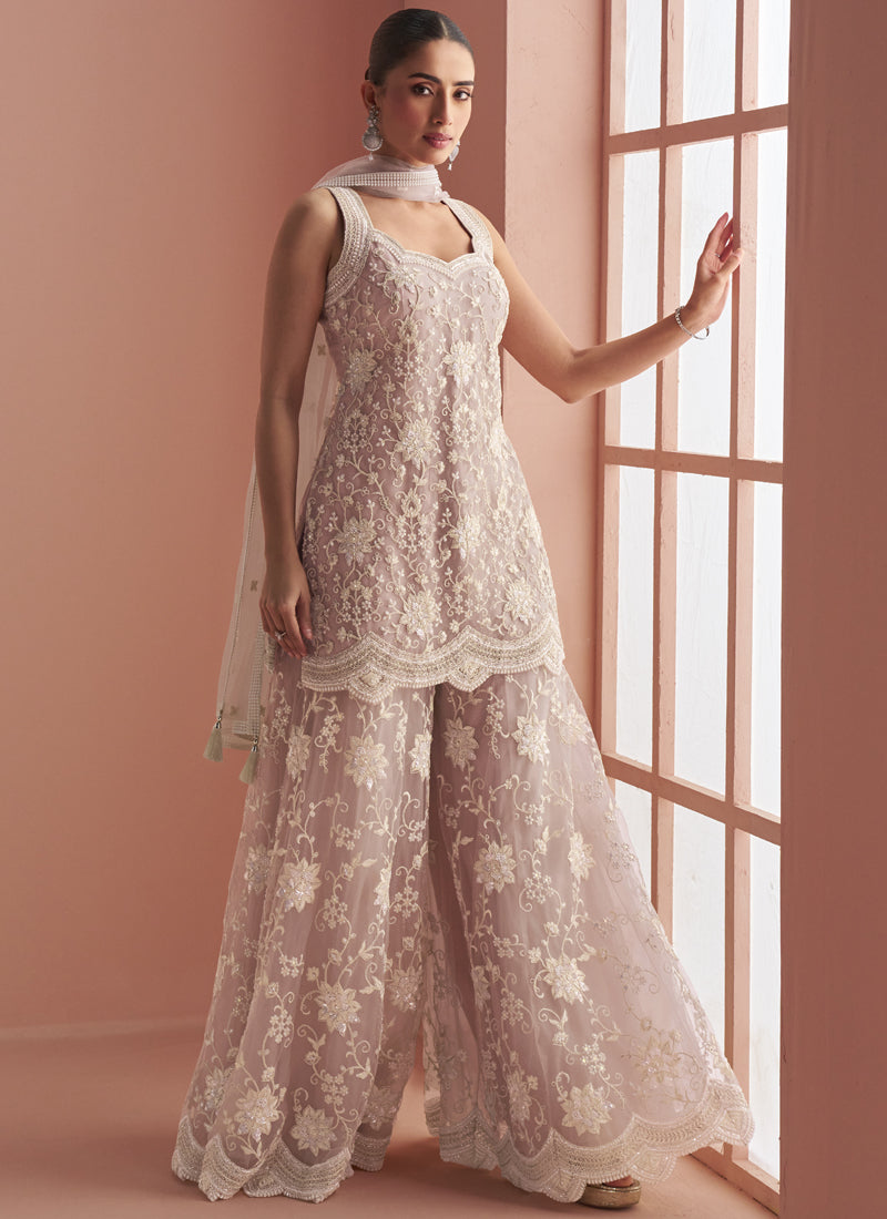 Light onion pink net palazzo suit with heavy embroidery and bead detailing for festive wear