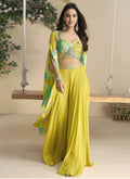 Woman wearing a yellow Chinon silk shrug style western suit with intricate Gota Patti embroidery.