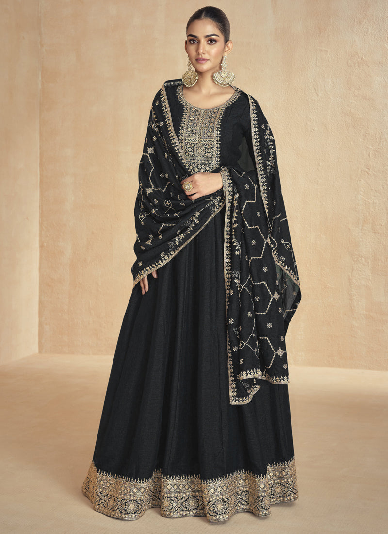 Black silk Anarkali suit with detailed gold gota patti and resham thread embroidery for festive wear.